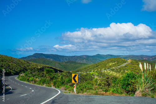 Monutain road winding through green ranges. Cape Reinga, North Island, New Zealand