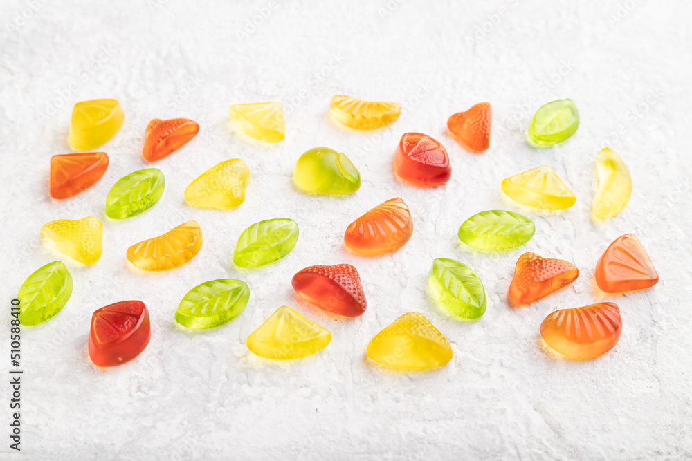 Various jelly candies on gray concrete background. close up, side view. Various jelly candies on gray concrete background. close up, side view.