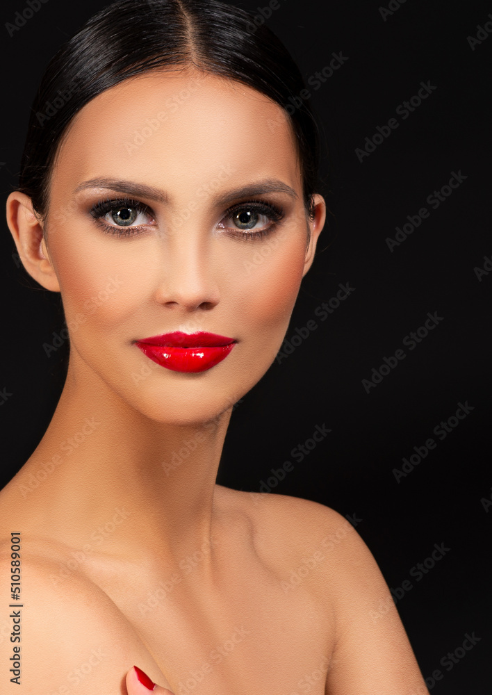 Brunette fashion model with smokey eyes and red lipstick make up on black background Brunette fashion model with smokey eyes and red lipstick make up on black background