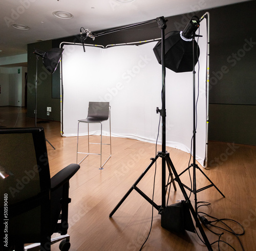 Filming set with lights, cameras and white background.