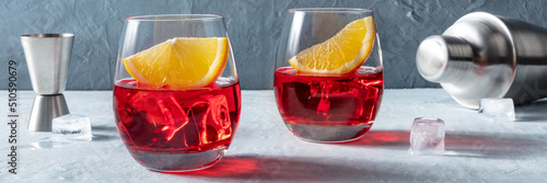 Fototapete Campari or negroni cocktails with fresh oranges, a jigger, and a shaker, a panor