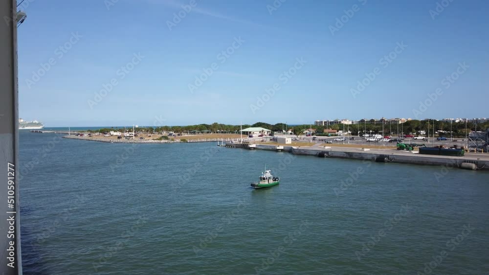 Brevard County Sheriff's Office boat watches as cruise vessel departs from Port Canaveral, Florida. Marine security for passenger ship leaving the dock in FL for a Caribbean cruise. Brevard County Sheriff's Office boat watches as cruise vessel departs from Port Canaveral, Florida. Marine security for passenger ship leaving the dock in FL for a Caribbean cruise.