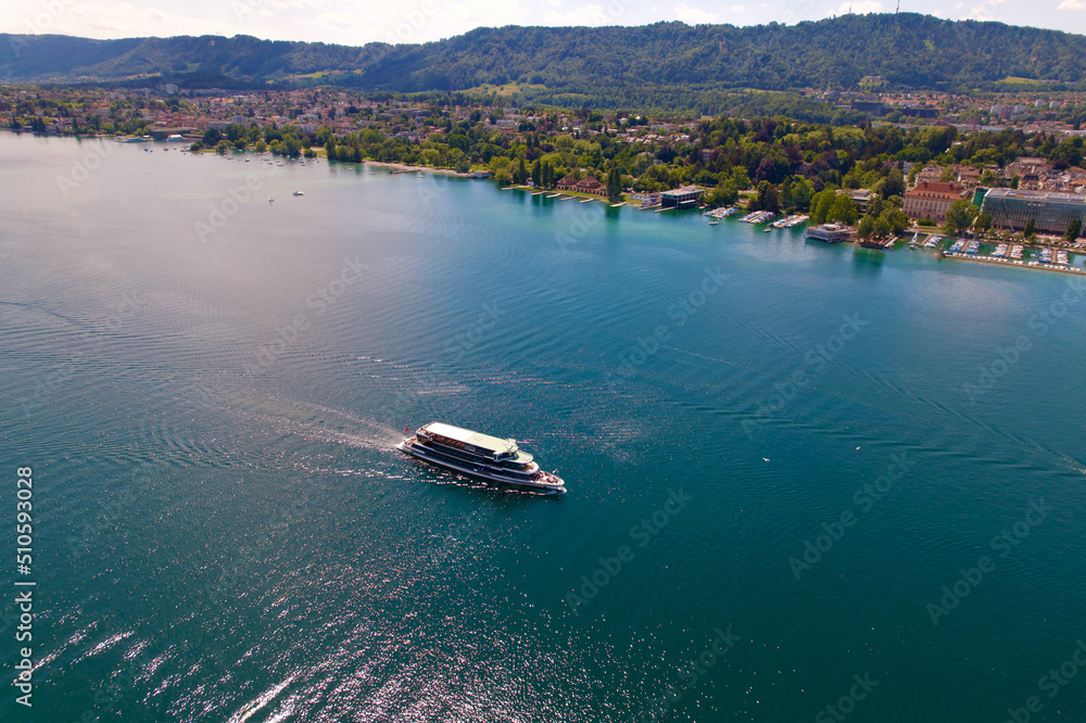 Obraz premium Aerial view of Passenger ship on Lake Zürich at City of Zürich on a sunny spring day. Photo taken May 30th, 2022, Zurich, Switzerland.