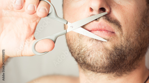 Fototapeta Naklejka Na Ścianę i Meble -  man scissors on beard