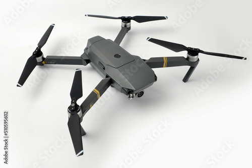 A gray camouflaged drone with a camera used for military espionage isolated. © TatnattanPhotos