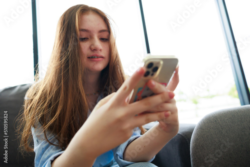 Smart phone. Young caucasian female student use martphone