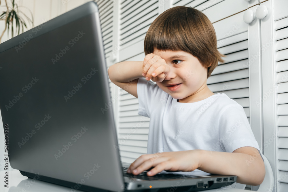 5 year boy uses laptop, closed eyes, tired, headached. Student abuse. Emotional stress. Difficult task. Accumulated fatigue. Online learning concept. The bad influence of computer games on a psyche 5 year boy uses laptop, closed eyes, tired, headached. Student abuse. Emotional stress. Difficult task. Accumulated fatigue. Online learning concept. The bad influence of computer games on a psyche
