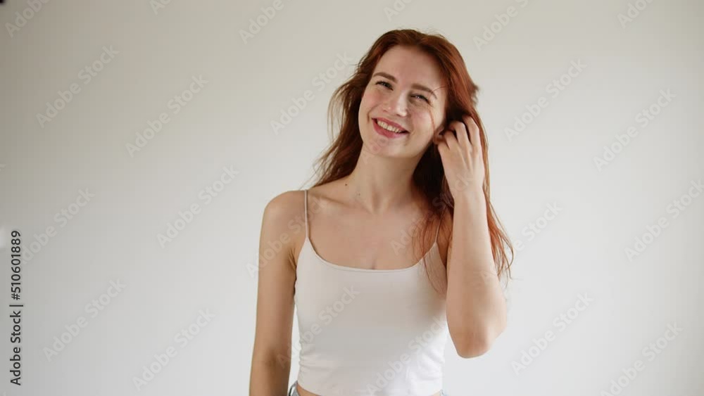 Beautiful young woman sexually pushes her hair out of her face. Beautiful young woman sexually pushes her hair out of her face.