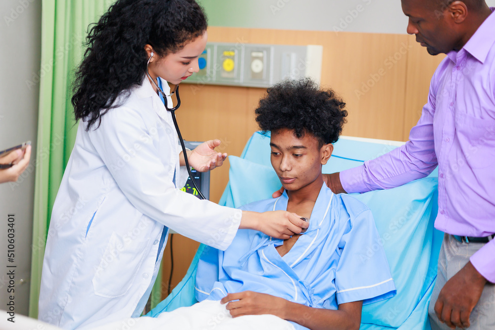 Obraz premium black woman doctor and man patient. black female doctor talking consulting and checkup by stethoscope with patient Hospital Healthcare and medicine concept.