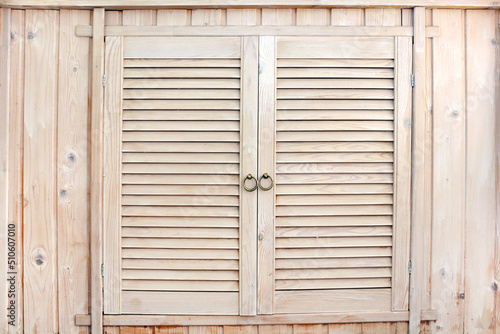 Rustic wooden cupboard. Handmade wooden locker in country style with louvered doors