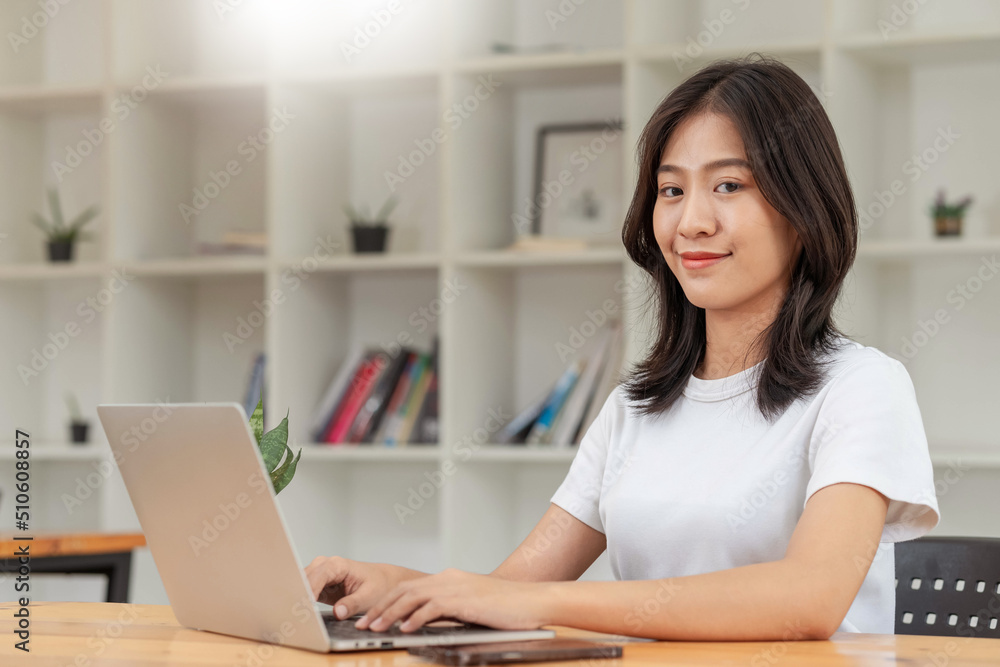 Lifestyle and technology concept, Young Asian woman using laptop and smartphone to working at home. Lifestyle and technology concept, Young Asian woman using laptop and smartphone to working at home.