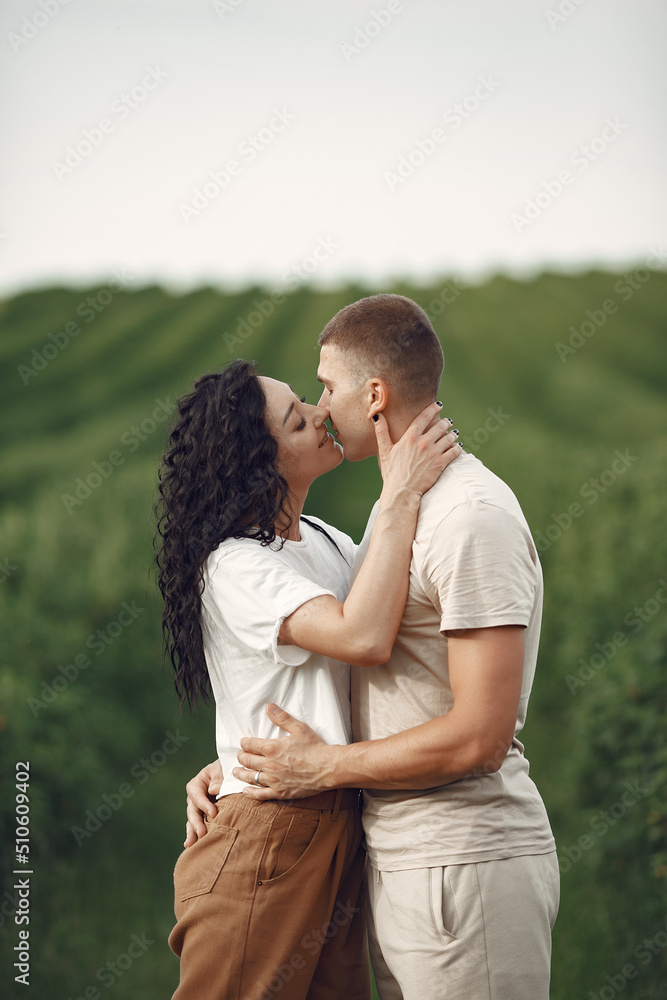 Beautiful couple spend time on a summer field Beautiful couple spend time on a summer field