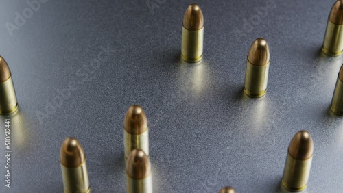 9mm pistol bullets resting on a cloth and camera spinning around. photo