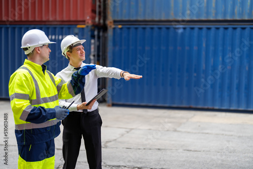 Container yard manager briefing work plan with the supervisor at container yard warehouse.
