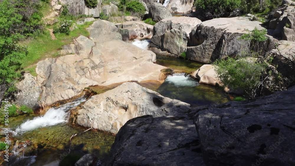 Waterfalls of a river descending on several levels between the rocks of the high mountain. Waterfalls of a river descending on several levels between the rocks of the high mountain.