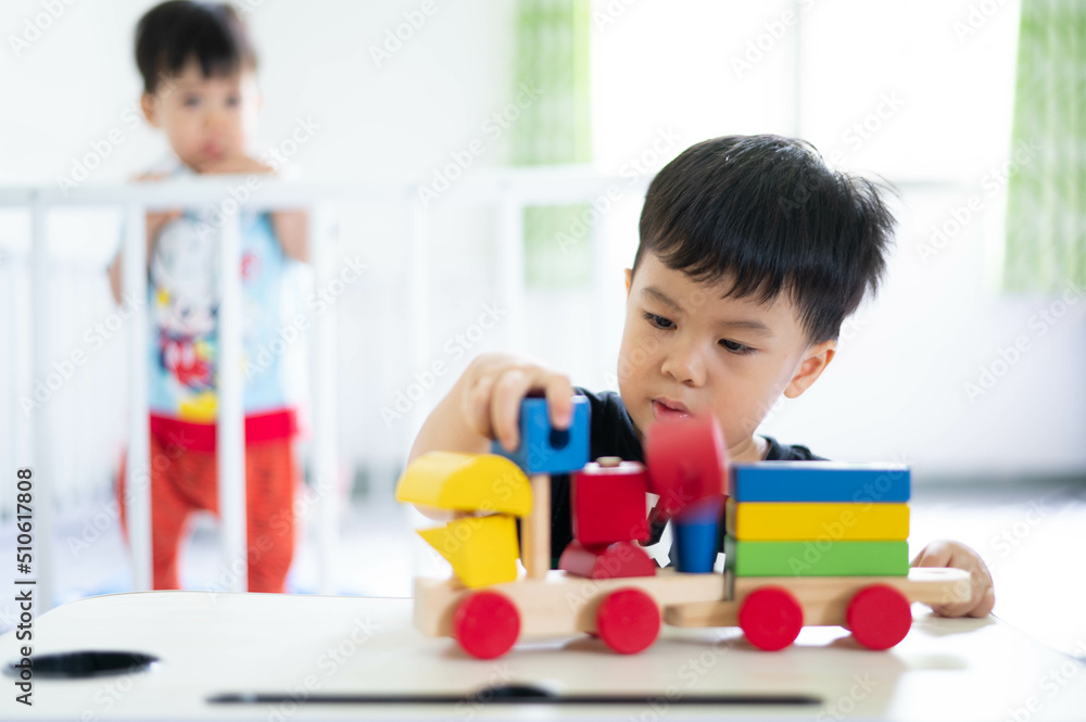 2 years old baby boy playing with wooden toy on the table 2 years old baby boy playing with wooden toy on the table
