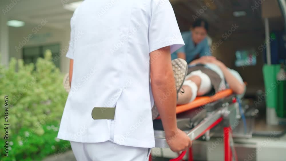Staff man and emergency team bring patient lie on stretcher bed into ambulance van and other staff help to support the patient. Staff man and emergency team bring patient lie on stretcher bed into ambulance van and other staff help to support the patient.