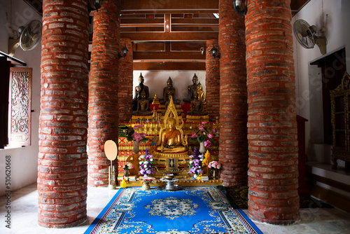 Ancient buddha statue for thai people travel visit and respect praying with blessing holy mystery worship at Wat Khao Nang Buat or Phra Achan Thammachot temple on May 27, 2022 in Suphan Buri, Thailand photo