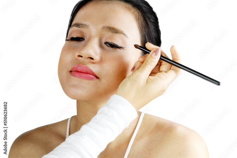 Woman being applied eyeshadow by makeup artist Woman being applied eyeshadow by makeup artist