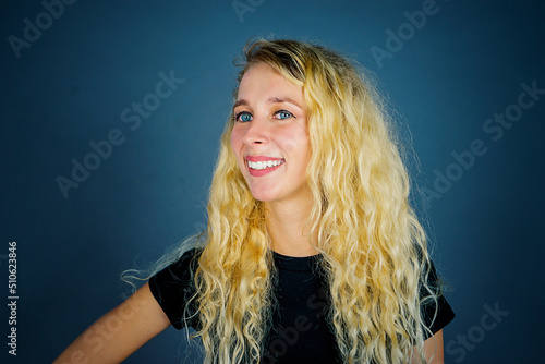 Blonde woman smiling at the camera on studio