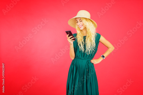 Blonde woman using a cellphone on studio