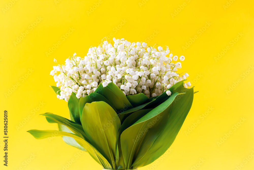 White lilies of the valley on a yellow background. Convallaria