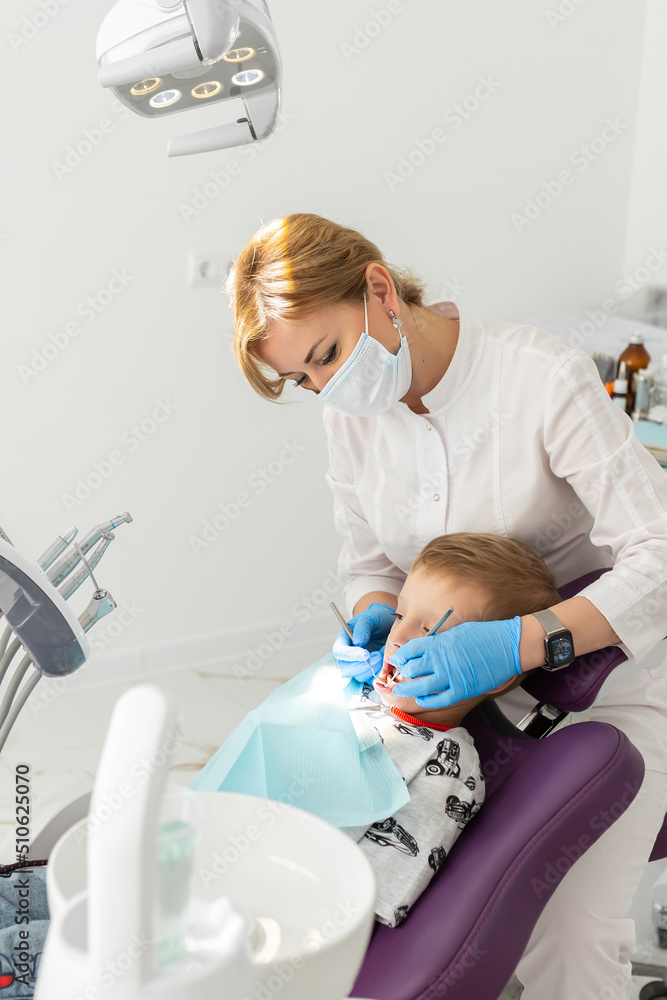 Dentist and kid patient in dentist office Dentist and kid patient in dentist office