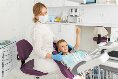 Dentist and kid patient in dentist office