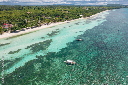 A few boats docked at Dumaluan Beach in the island of Panglao, Philippines. photo