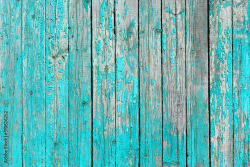 Vintage wall made of old wooden boards with peeling paint.