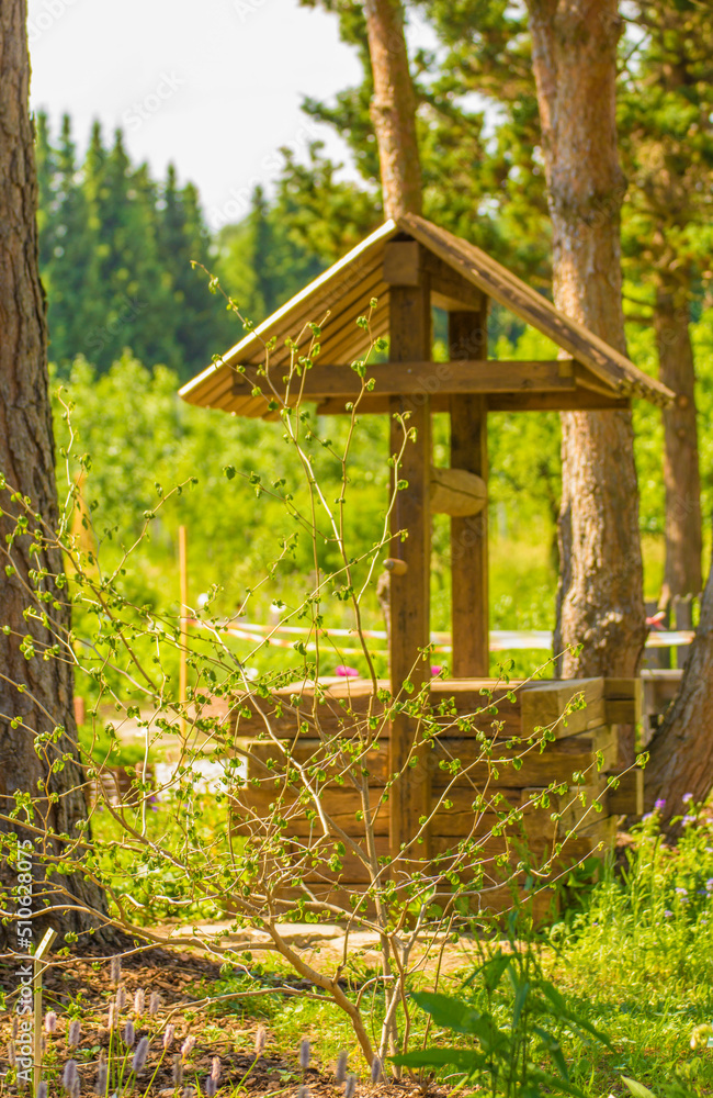 old wooden well on the background of green nature old wooden well on the background of green nature