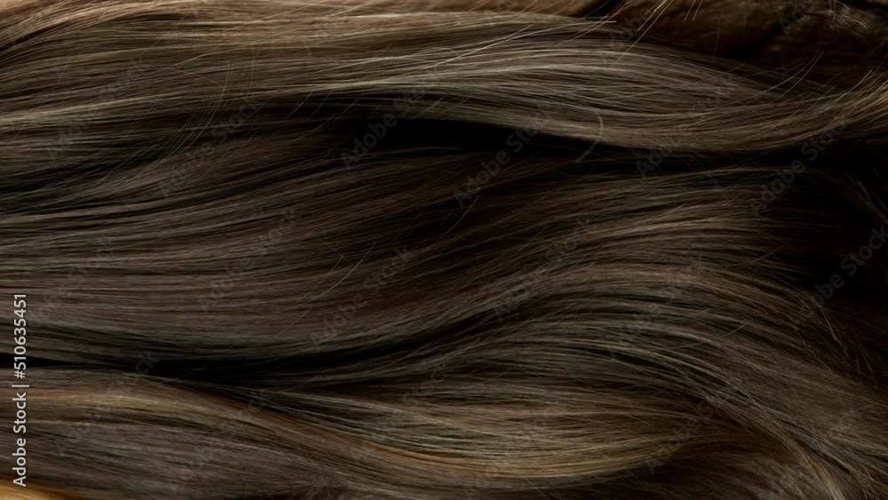 Super slow motion of wavy brown hair in detail. Filmed on high speed cinema camera, 1000 fps. Super slow motion of wavy brown hair in detail. Filmed on high speed cinema camera, 1000 fps.