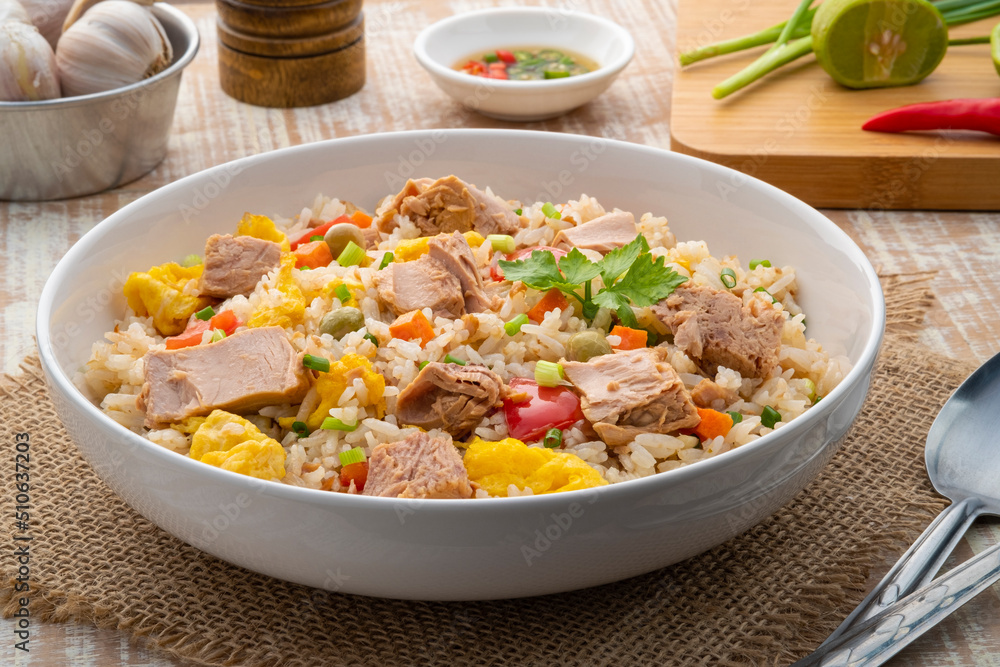 Tuna fried rice, Pan stir fry cooked rice with canned tuna fish ,tomato ,carrot ,peas and egg.Quick and Easy one dish meal on white plate Tuna fried rice, Pan stir fry cooked rice with canned tuna fish ,tomato ,carrot ,peas and egg.Quick and Easy one dish meal on white plate