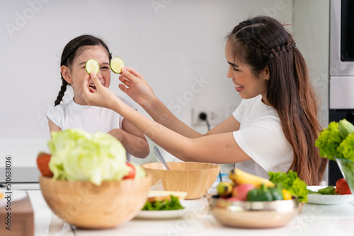 Asian girl learning to cook with her mother. Do activities together with your family in a fun and joyful way. There is a mother who takes care of closely