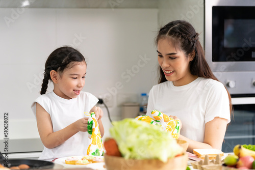 Asian girl learning to cook with her mother. Do activities together with your family in a fun and joyful way. There is a mother who takes care of closely