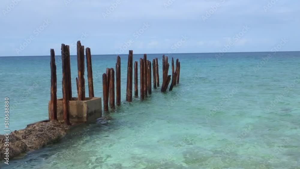 Caribbean sea with sticks going into the sea Caribbean sea with sticks going into the sea