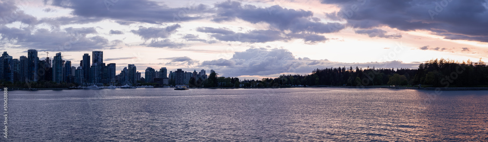 Seawall around Stanley Park with Highrise Buildings in background. Modern City Skyline. Downtown Vancouver, British Columbia, Canada. Dramatic Sunset Sky. Panorama