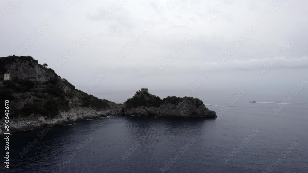 Drone video of a descriptive empty plane in the direction of the Capo de Conca tower, on the Amalfi coast, Italy. Two navengango boats appear in the scene. Drone video of a descriptive empty plane in the direction of the Capo de Conca tower, on the Amalfi coast, Italy. Two navengango boats appear in the scene.