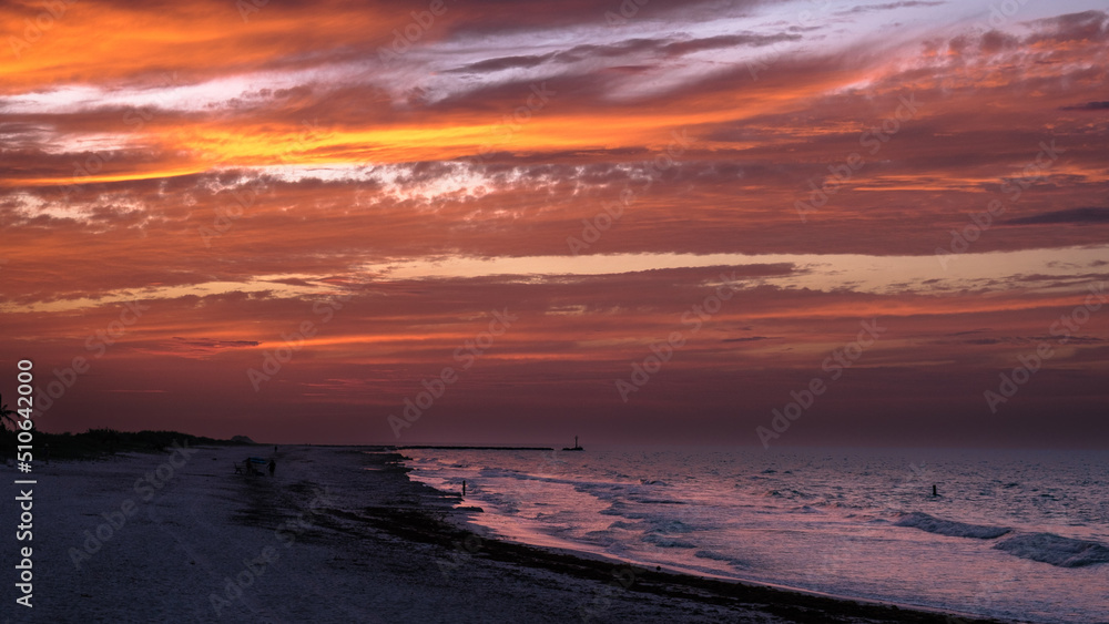 Red sunset over the Caribbean sea with clouds