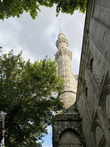 Islamic background photo. Minaret of Sehzade Mosque and trees. Islamic architecture or ramadan or kandil or laylat al-qadr or kadir gecesi background. Selective focus. photo