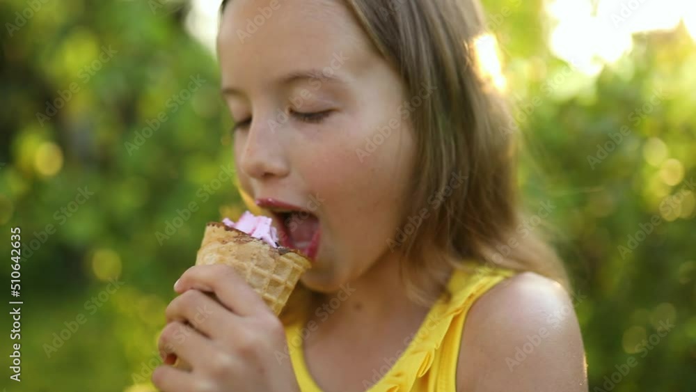 Cute girl with braces eating italian ice cream cone smiling while resting in park on summer day, child enjoying ice cream outdoor, happy holidays, summertime Cute girl with braces eating italian ice cream cone smiling while resting in park on summer day, child enjoying ice cream outdoor, happy holidays, summertime