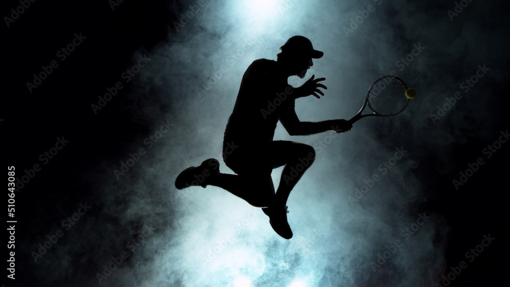 Dramatic tennis player silhouette jumping up in the air