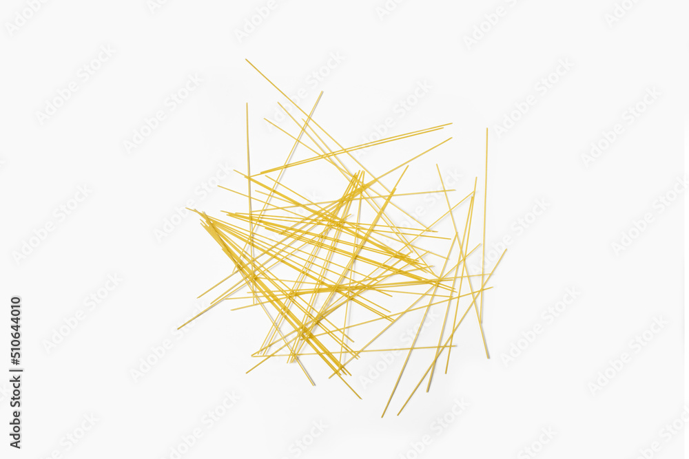 Raw long spaghetti on a white background. Top view, flat lay. Raw long spaghetti on a white background. Top view, flat lay.