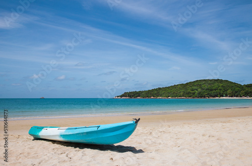 A kayak at beautiful tropical beach with the mountain background, white sand, turquoise ocean water and blue sky at Samed Islands in Thailand