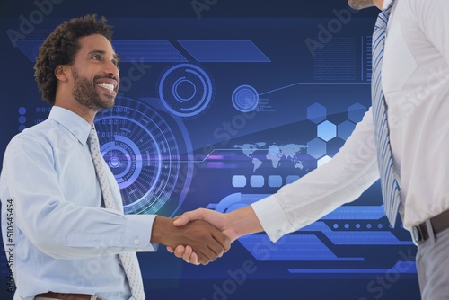 Two diverse businessmen shaking hands against digital interface with data processing