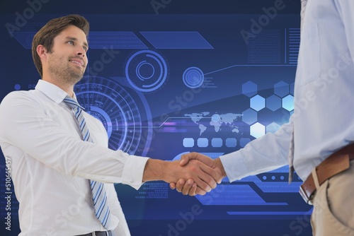 Two diverse businessmen shaking hands against digital interface with data processing