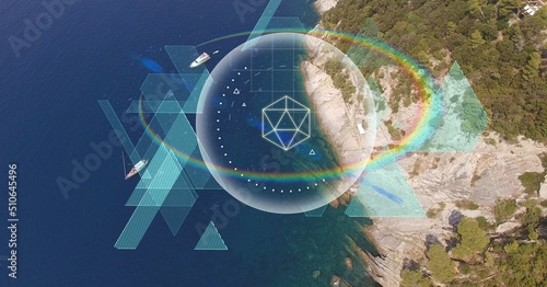 Abstract geometric shapes and rainbow flare over aerial view of a island