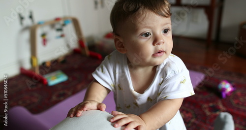 Cute baby boy infant standing up at home