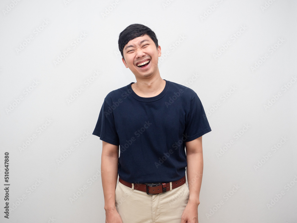 Portrait positive young man laugh standing on white background studio shot Portrait positive young man laugh standing on white background studio shot