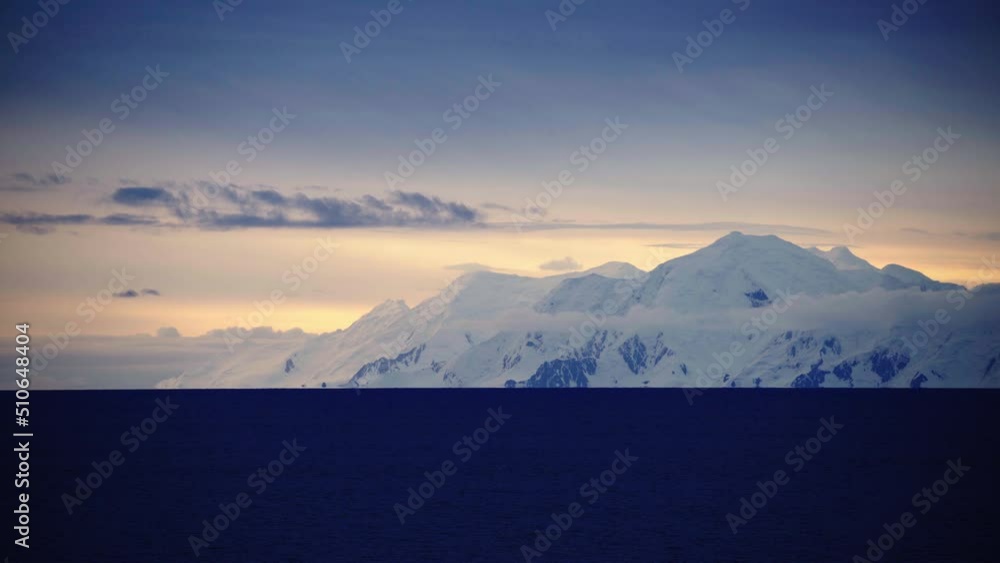 Point Of View Tranquil Snow Covered Mountains By Sea Against Cloudy Sky - Patagonia, Argentina Point Of View Tranquil Snow Covered Mountains By Sea Against Cloudy Sky - Patagonia, Argentina